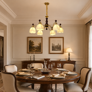 6-light yellow fabric chandelier above a round dining table