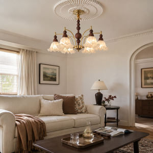 6-light white glass chandelier above a cosy living room coffee table