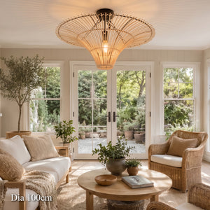 100cm rattan saucer ceiling light above a sunlit lounge with armchairs
