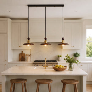 3-light walnut wood mini pendant adding warm light to a dining space
