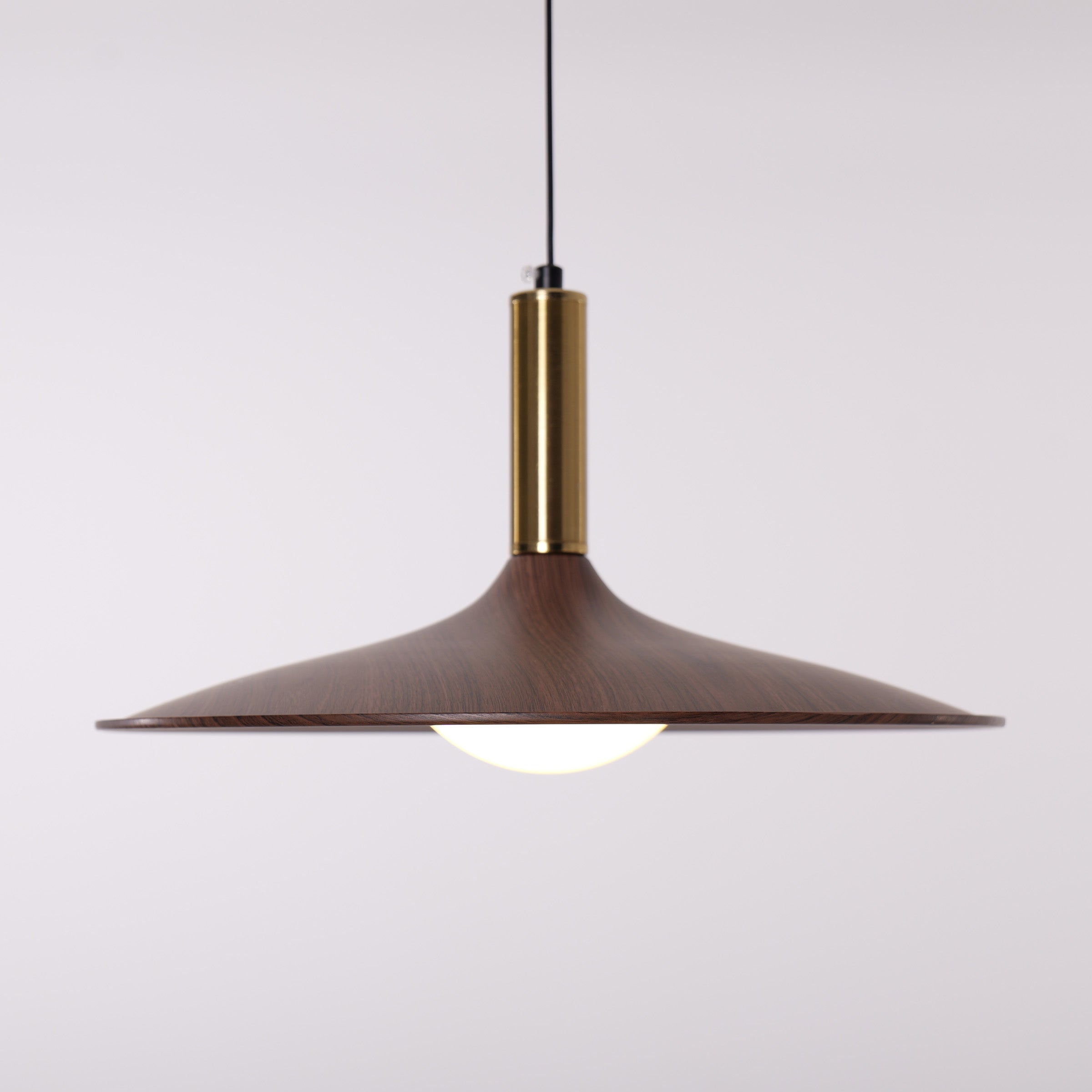 walnut double pendant light hung above a dining table