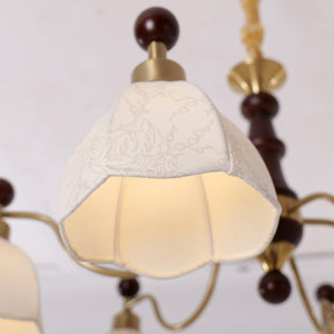 6-light chandelier with yellow fabric shades adding soft light to a bedroom