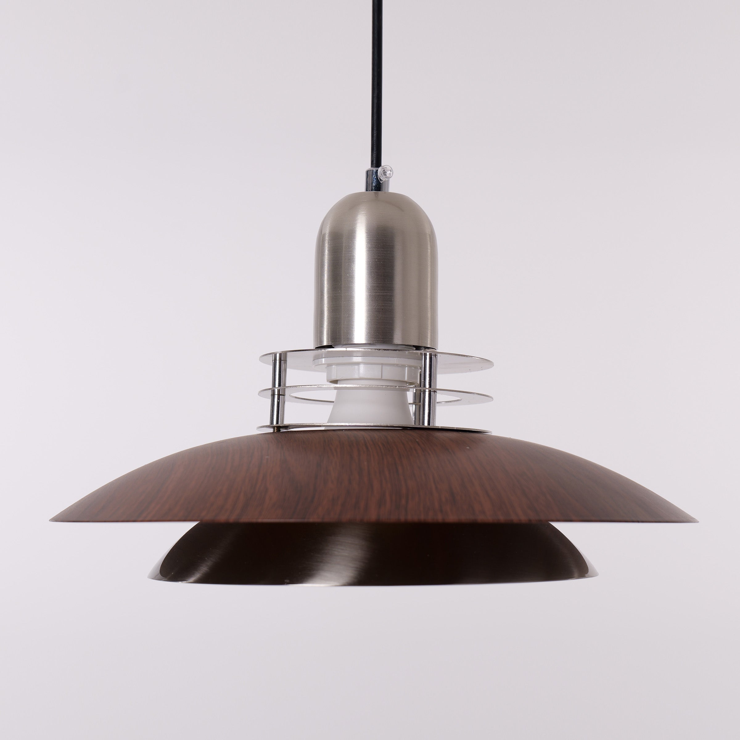 3-light walnut iron bar pendant styled in a calm bedroom