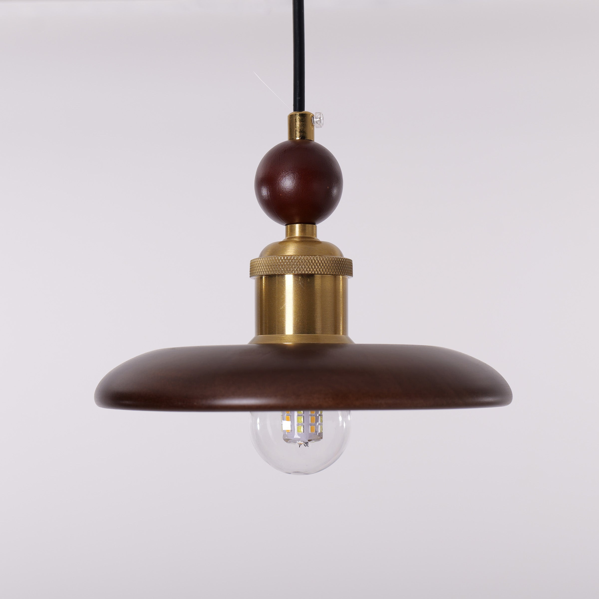 3-light walnut wood mini pendant styled in a calm bedroom