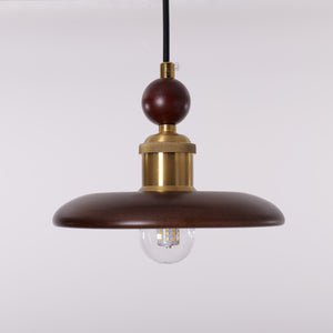 3-light walnut wood mini pendant styled in a calm bedroom