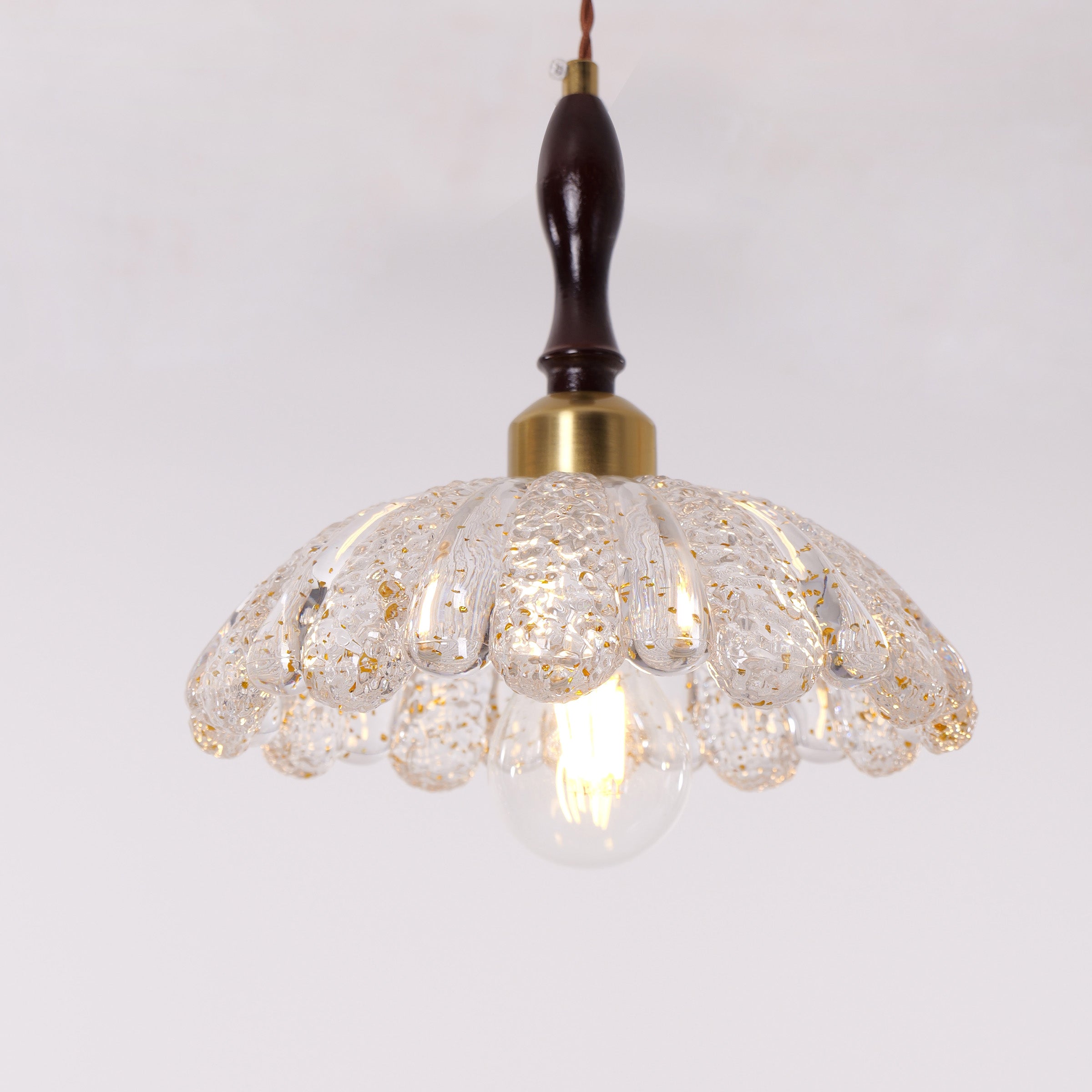 3-light walnut resin mini pendant styled in a calm bedroom
