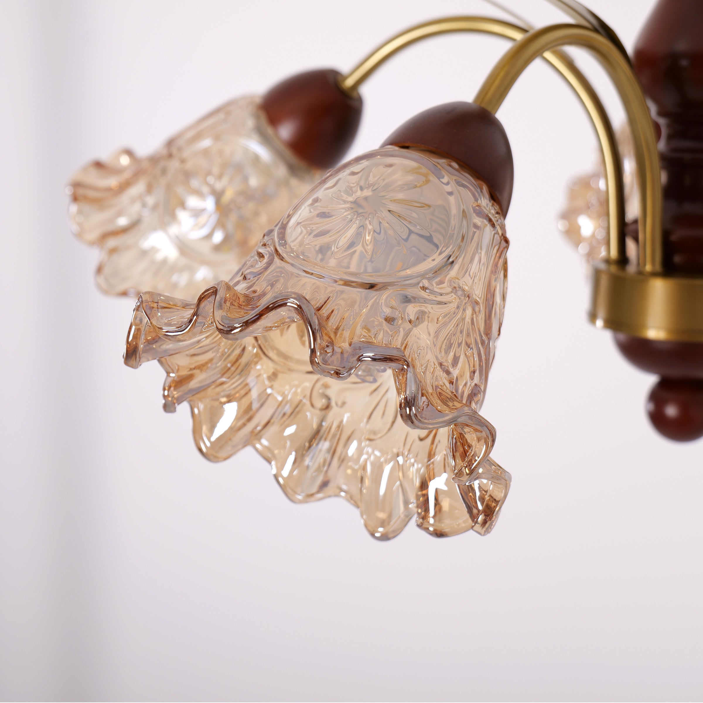 5-light copper chandelier with flower glass shades styled in a warm living room