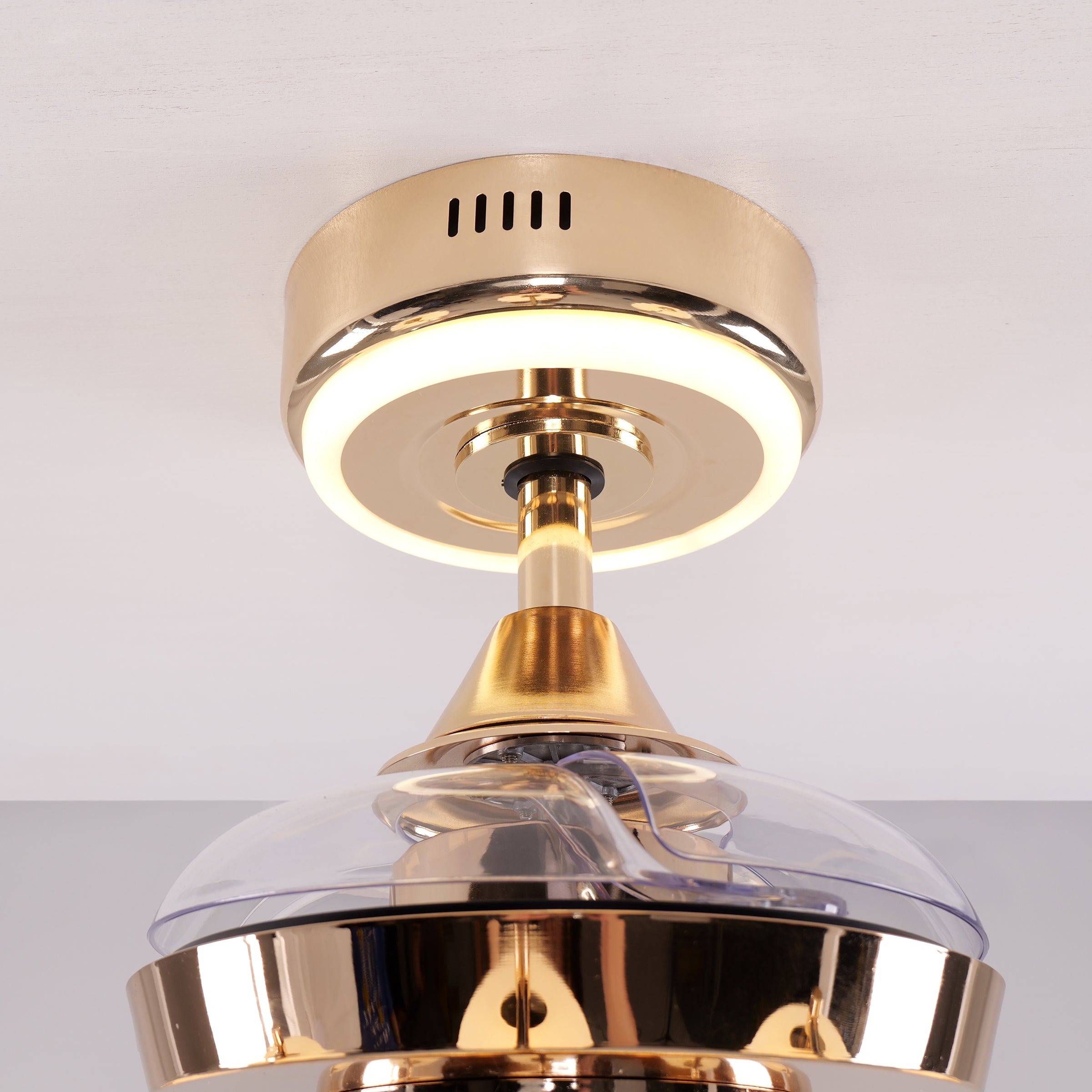 Copper ceiling fan light close-up showing clear fan blades below the canopy