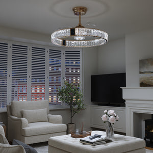 Gold ceiling fan with crystal light fitted in a modern living room setting