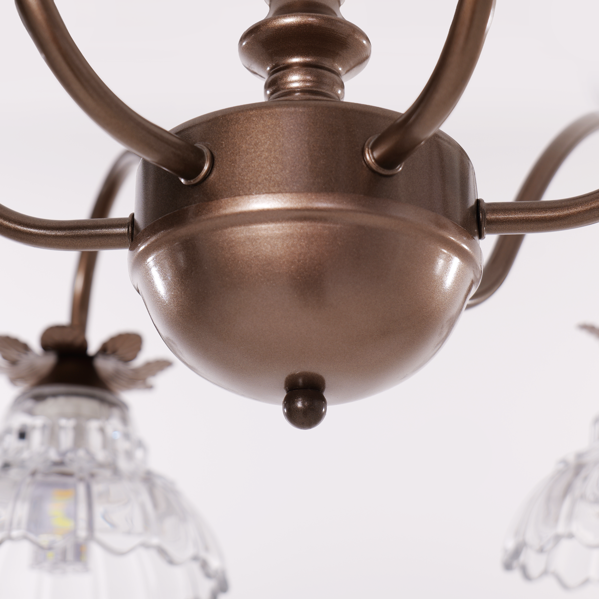 gold 6-light floral glass chandelier glowing above a dining table