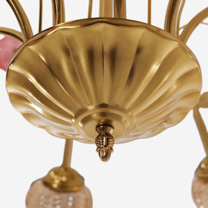 gold 8-light chandelier with pink floral glass shades in an elegant lounge setting