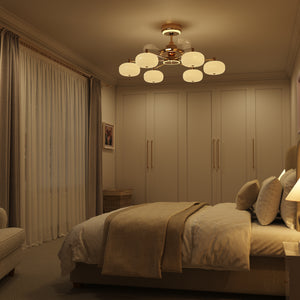 Warm copper ceiling fan light illuminating a cosy beige bedroom