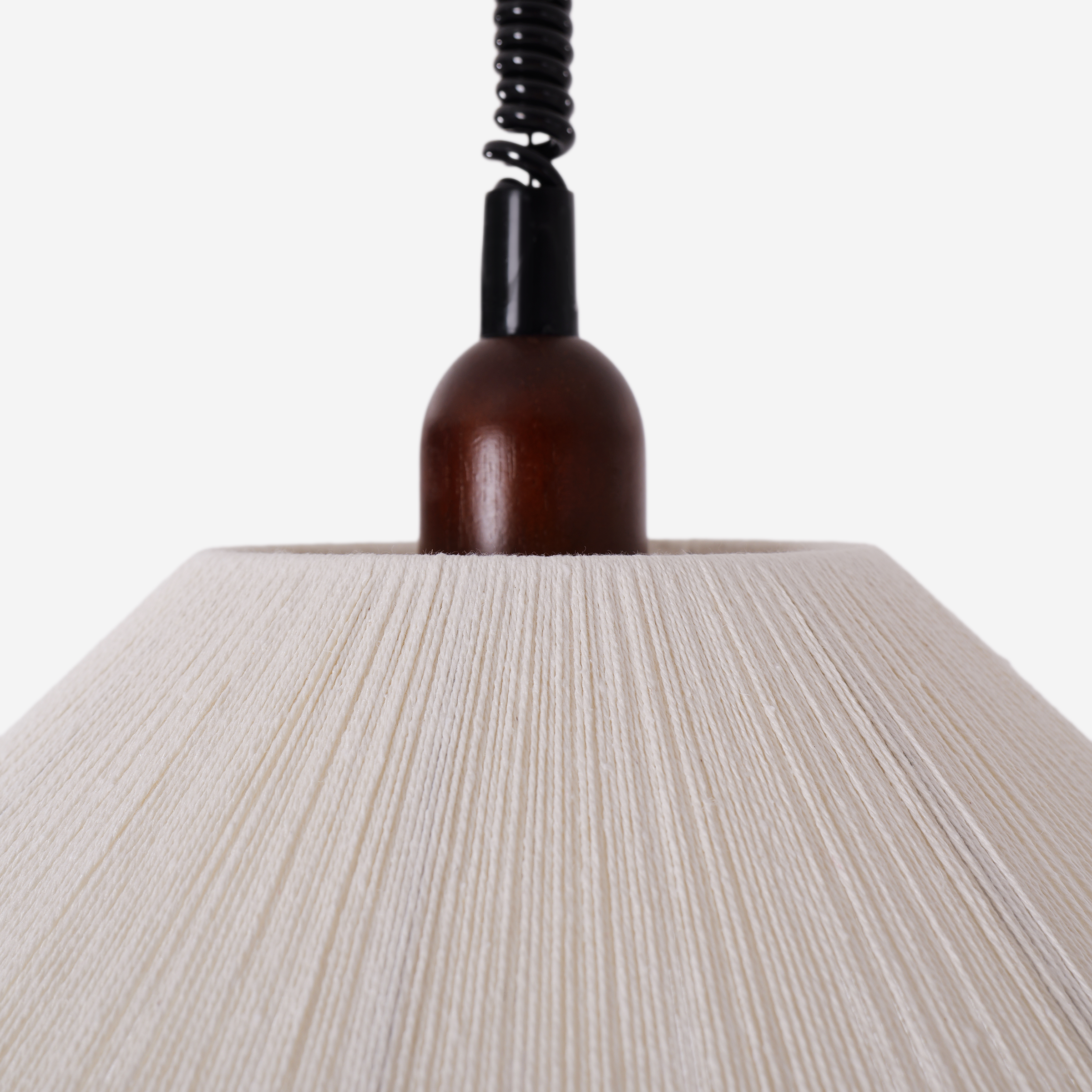 natural wood curved pendant light adding warm light to a dining space