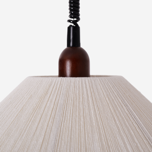 natural wood curved pendant light adding warm light to a dining space