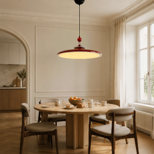red iron pendant light styled in a calm bedroom