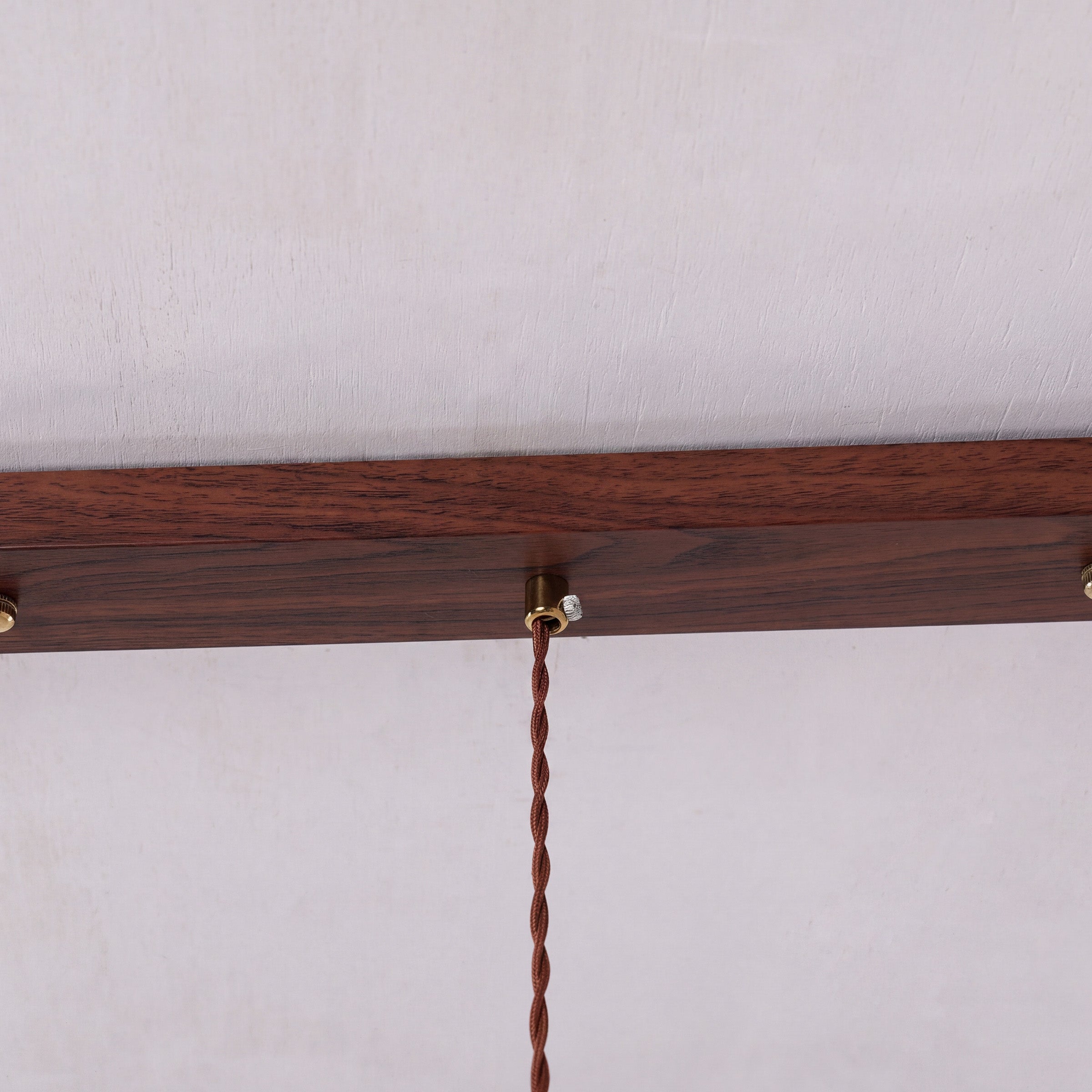 3-light walnut resin mini pendant adding warm light to a dining space