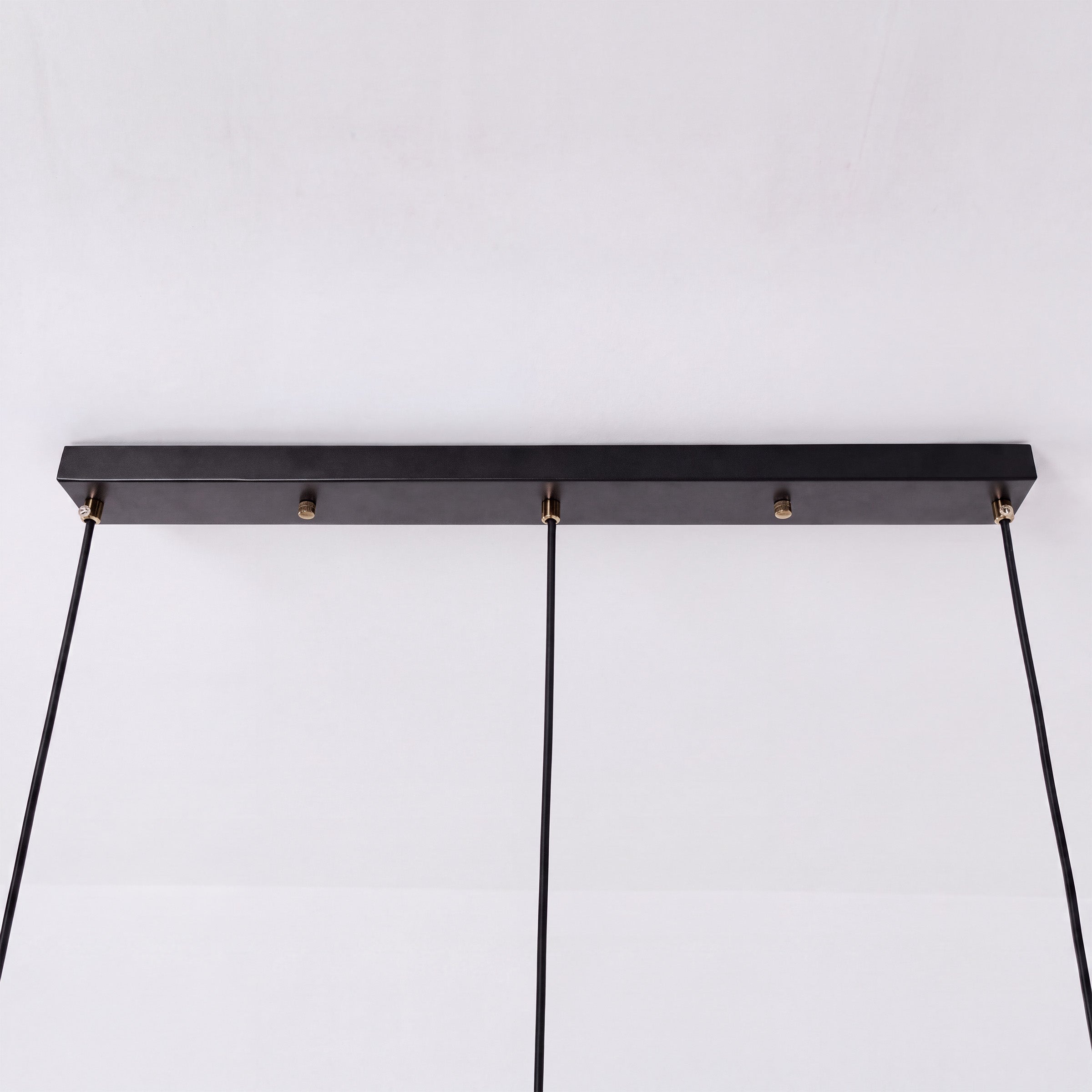 3-light walnut wood mini pendant beside a cosy seating area