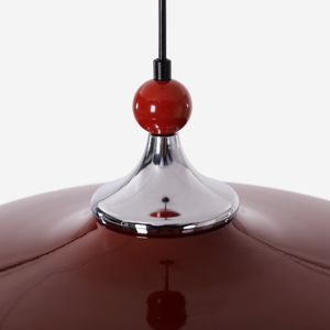 red iron pendant light beside a cosy seating area