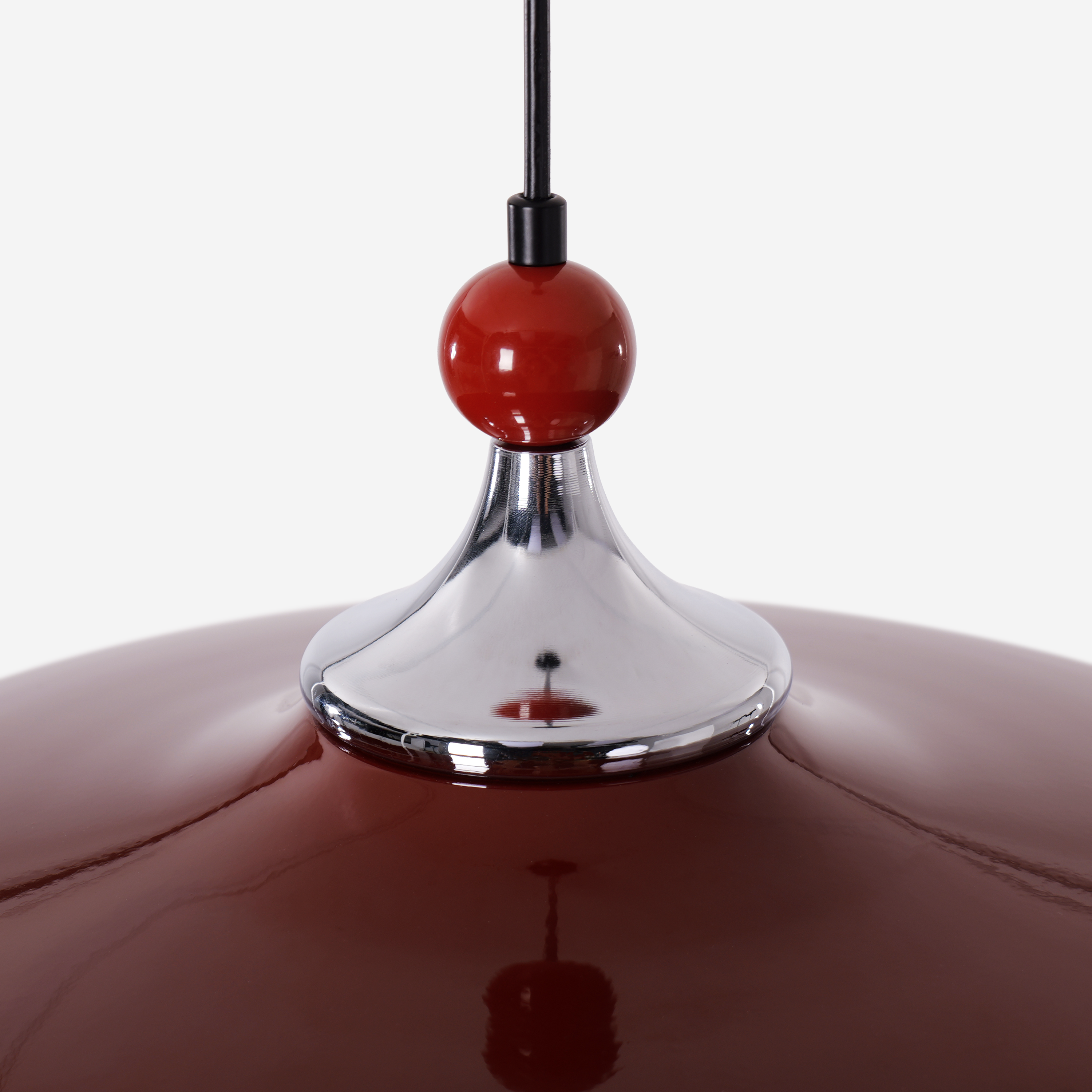 red iron pendant light beside a cosy seating area