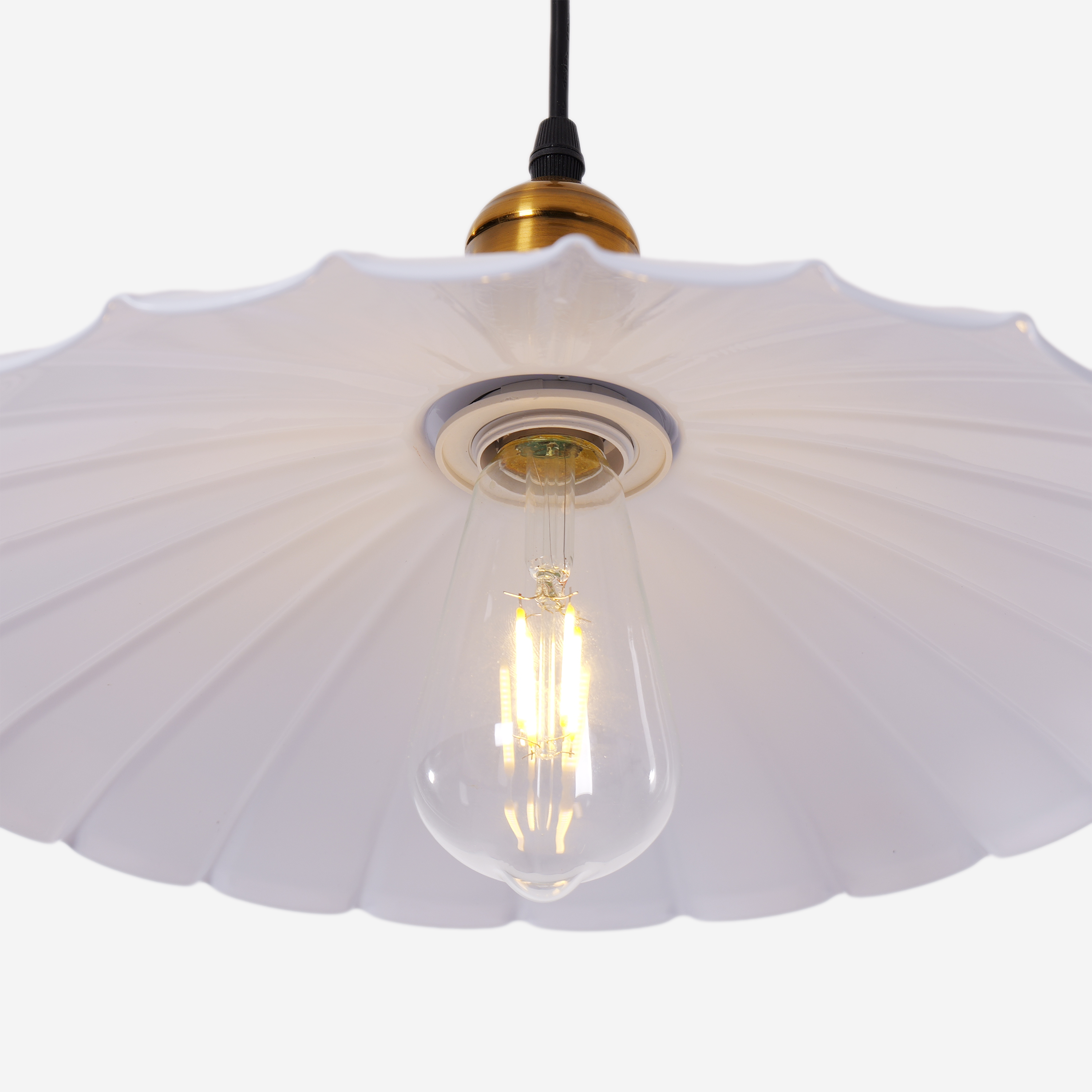 white iron pendant light hung above a dining table
