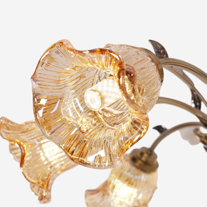 antique bronze chandelier with amber flower shades adding soft light to a bedroom