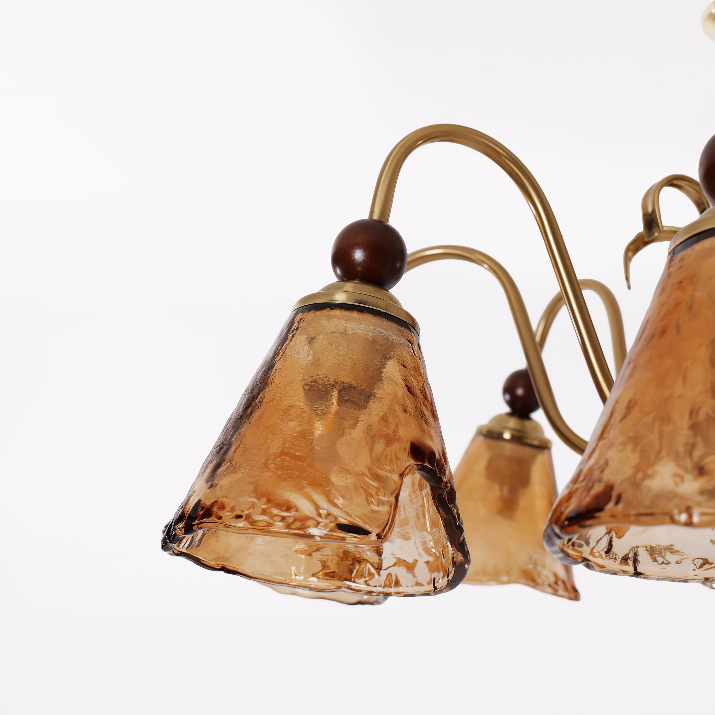 8-light walnut chandelier with amber cut glass shades styled in a warm living room