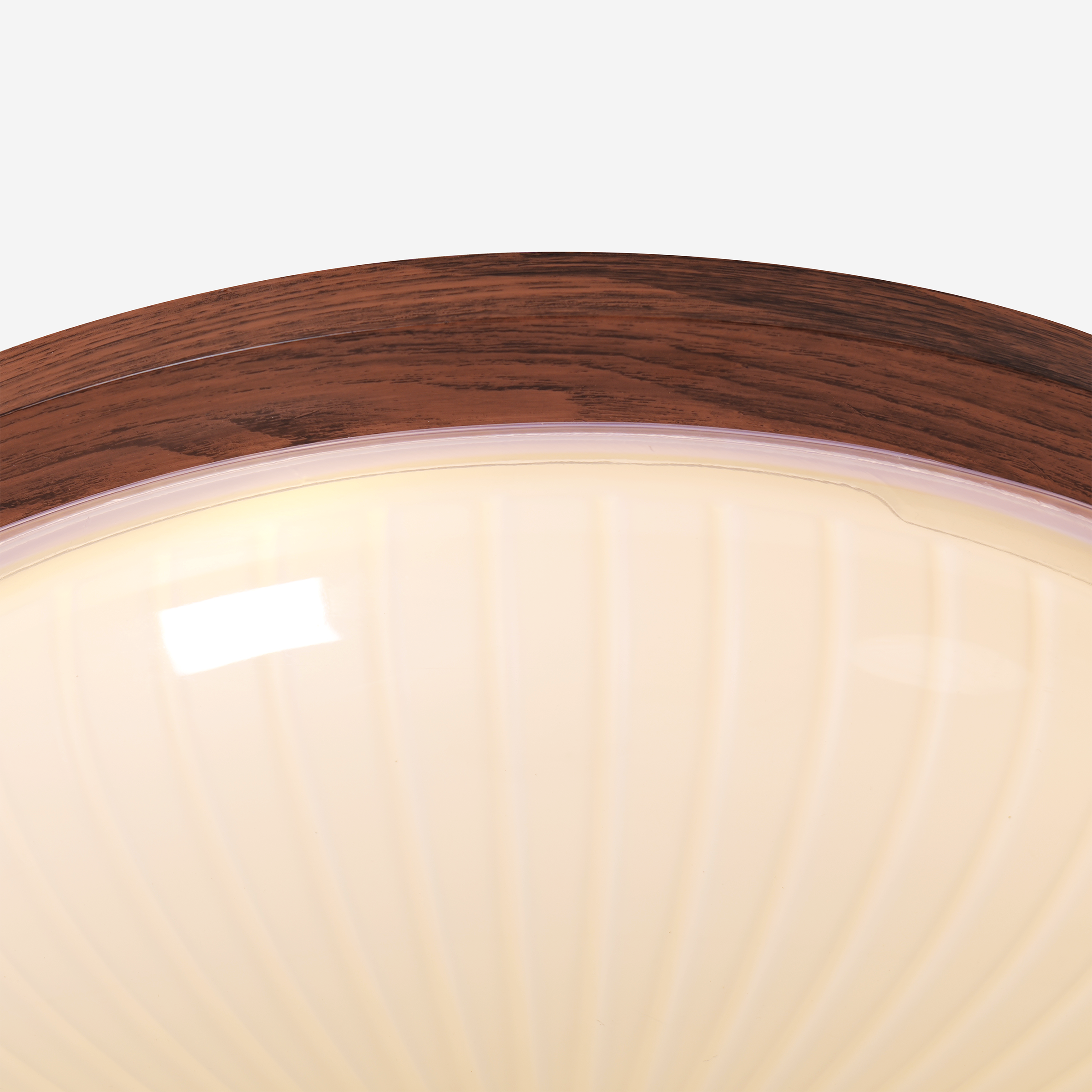 walnut ribbed acrylic ceiling light adding warm light to a bedroom