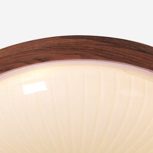 walnut ribbed acrylic ceiling light adding warm light to a bedroom