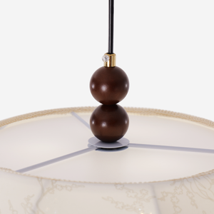 yellow fabric pendant light beside a cosy seating area
