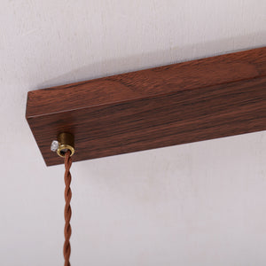 3-light walnut resin mini pendant beside a cosy seating area