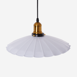 white iron pendant light adding warm light to a dining space