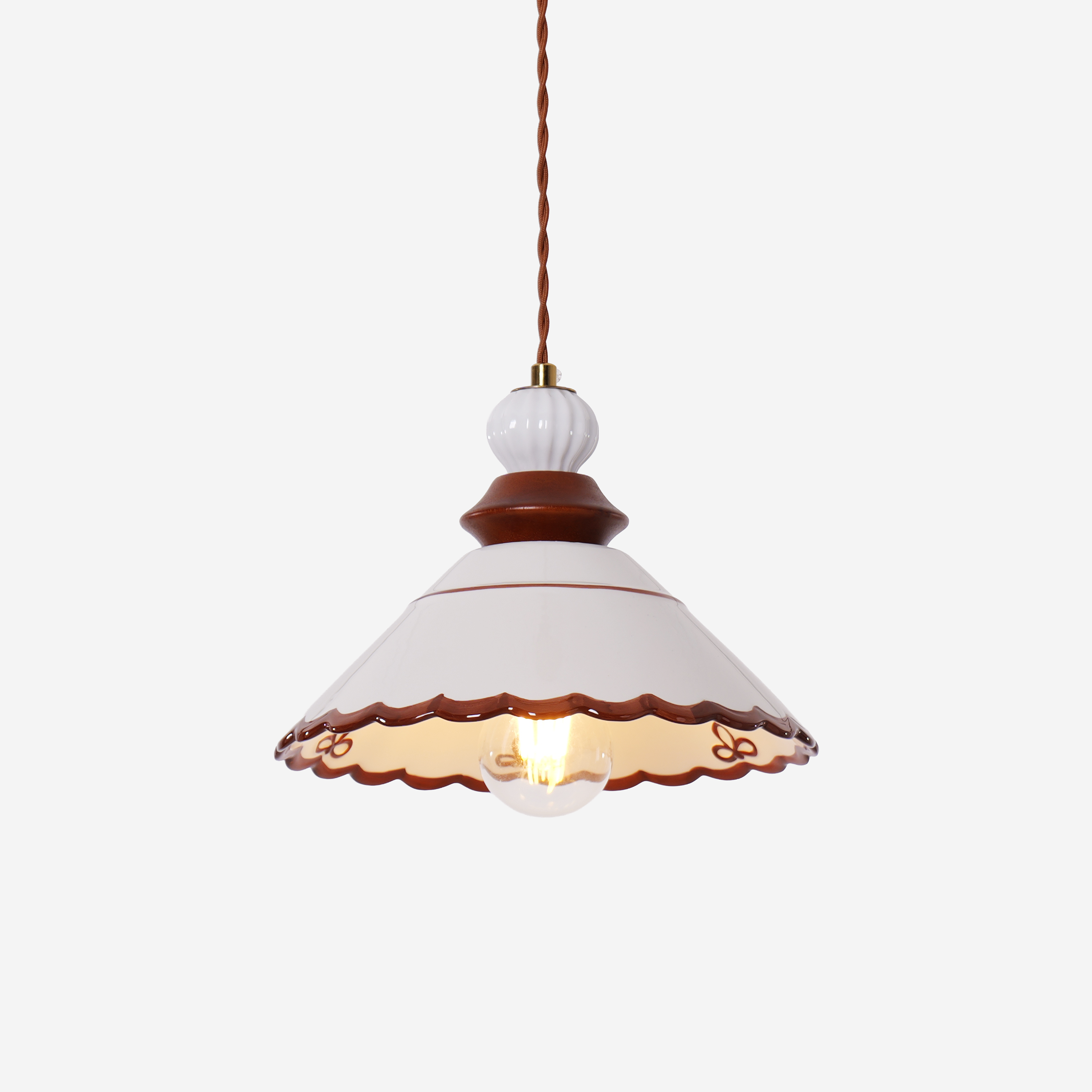 brown ceramic lace pendant light styled in a calm bedroom