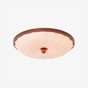walnut scalloped acrylic ceiling light adding warm light to a bedroom