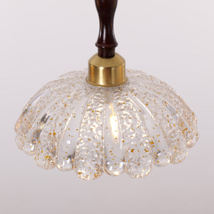 3-light walnut resin mini pendant hung above a dining table