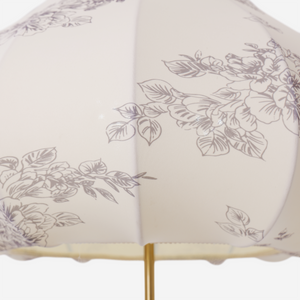 yellow floral fabric pendant light styled in a calm bedroom