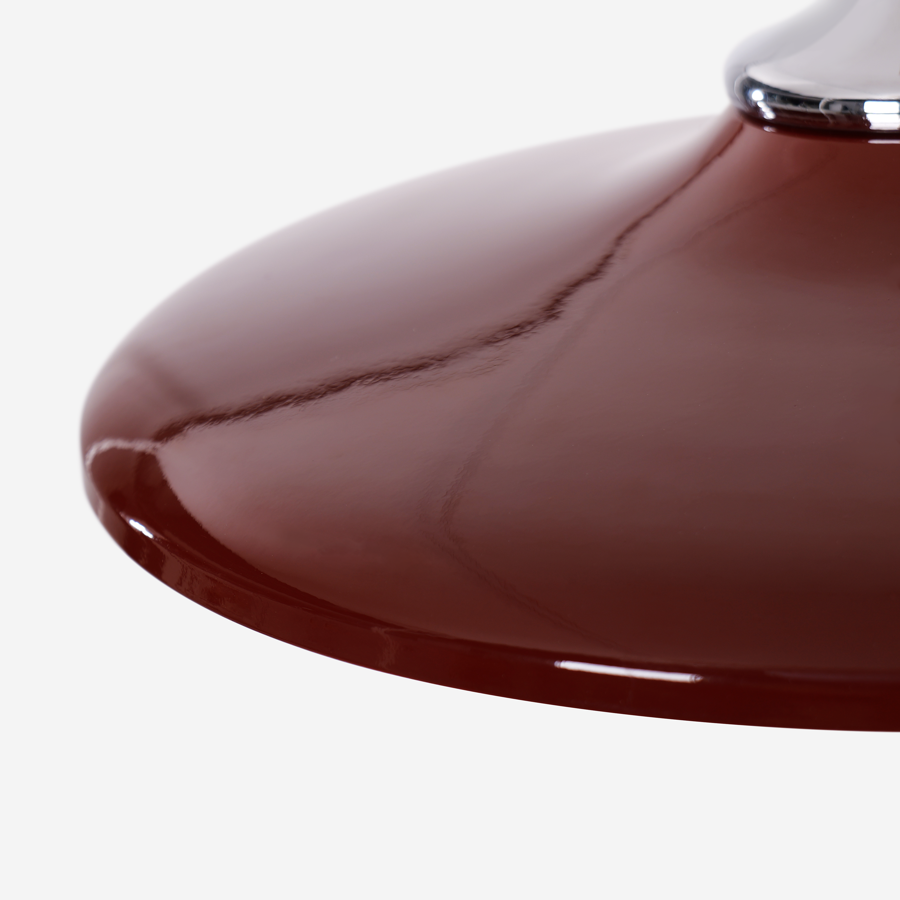 red iron pendant light adding warm light to a dining space