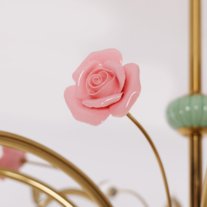 gold 8-light chandelier with pink floral glass shades adding soft light to a bedroom