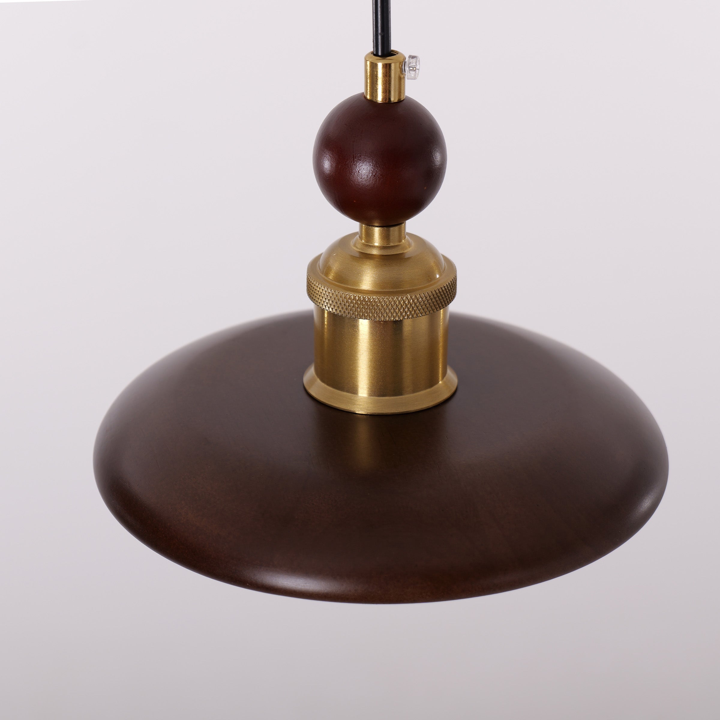 3-light walnut wood mini pendant hung above a dining table