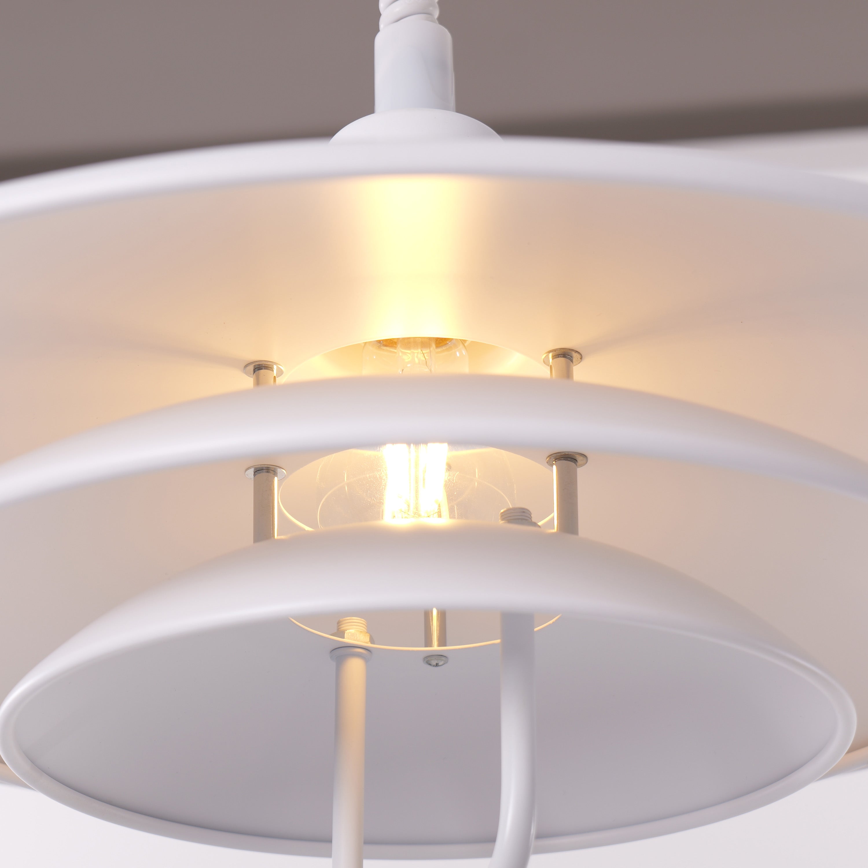 white layered minimalist pendant light styled in a calm bedroom
