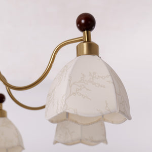 6-light chandelier with yellow fabric shades styled in a warm living room
