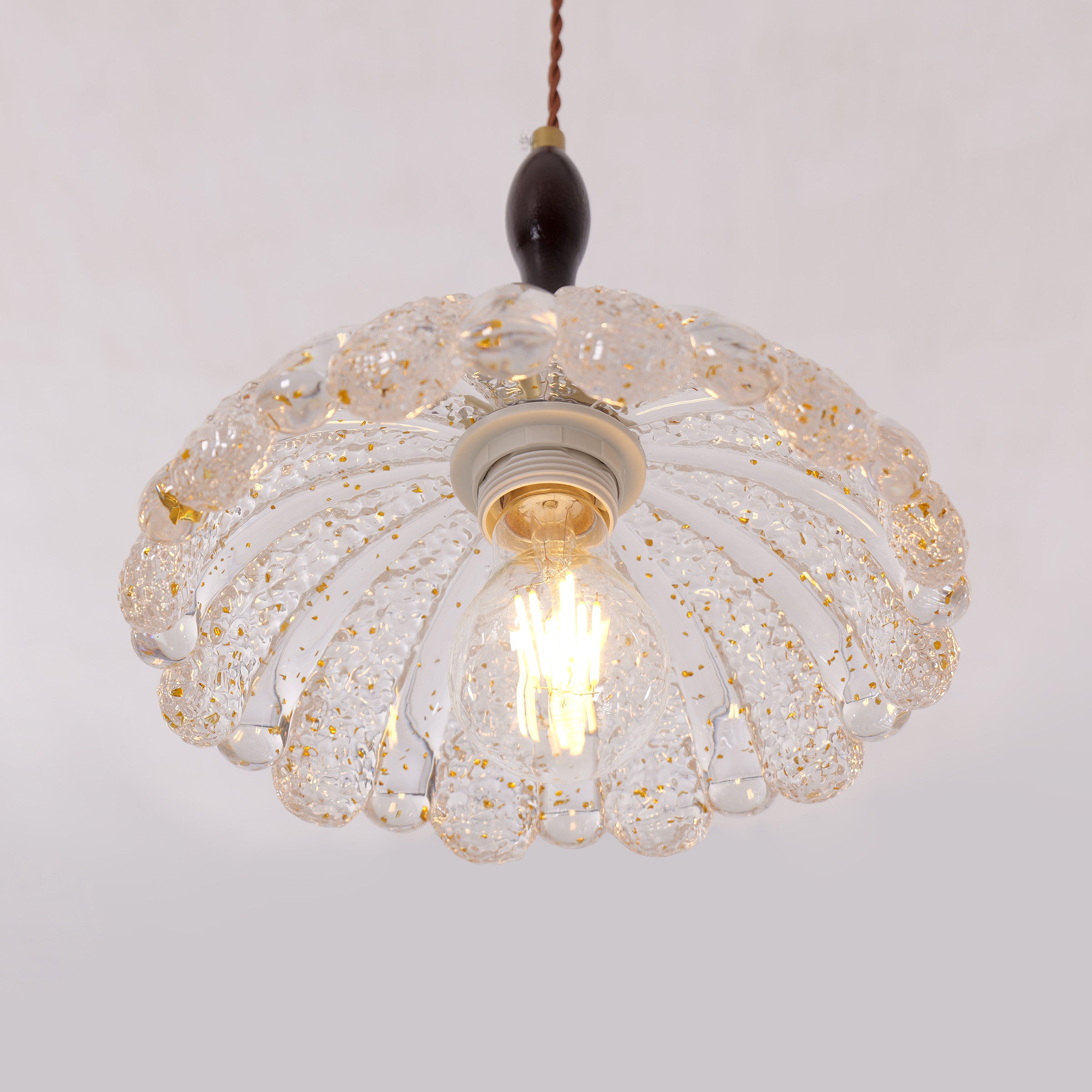 3-light walnut resin mini pendant over a kitchen island