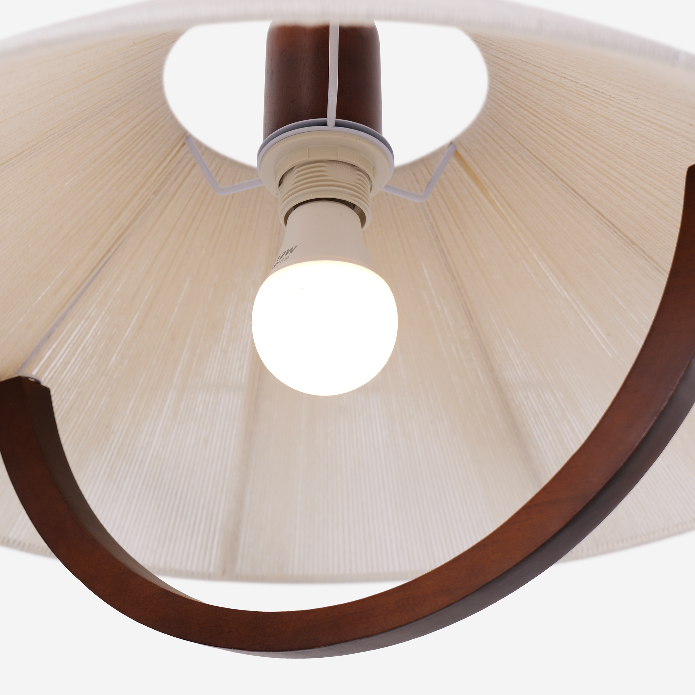 natural wood curved pendant light styled in a calm bedroom