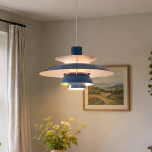 blue layered minimalist pendant light hung above a dining table
