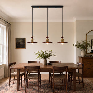 3-light walnut wood mini pendant beside a cosy seating area