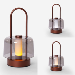 portable lantern-style ambient table lamp on a desk with soft ambient light