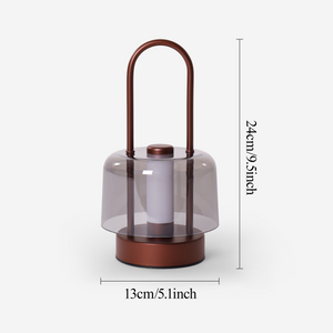 portable lantern-style ambient table lamp beside books and evening decor
