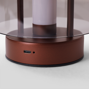 portable lantern-style ambient table lamp adding warm light to a bedroom