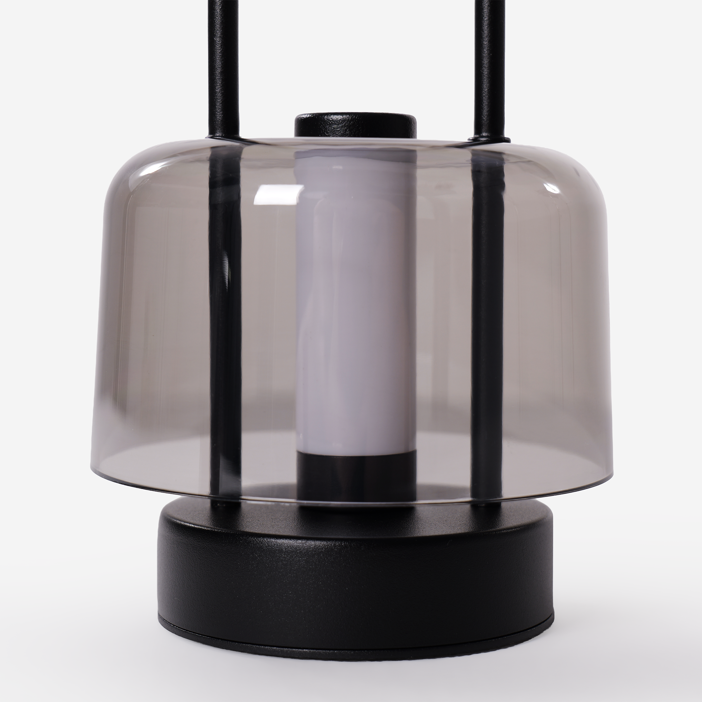 portable lantern-style ambient table lamp on a desk with soft ambient light