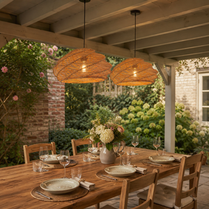 pair of woven rattan pendant lights above an outdoor garden dining table