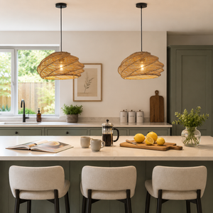 two rattan spiral pendant lights over a modern kitchen island with white stools